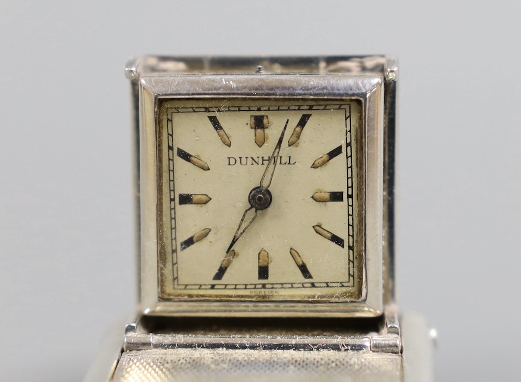 A 1930's engine turned silver traveling watch, retailed by Dunhill, with engraved name, import marks for Hernu, Peron & Stockwell Ltd? London, 1937, 35mm.
